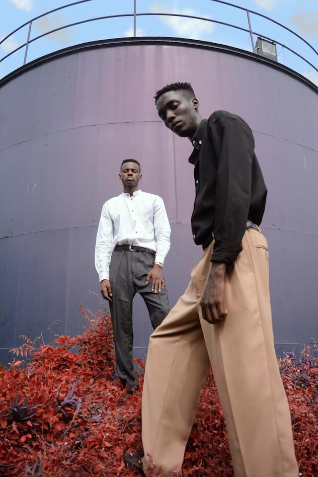 to men standing in front of a large fashion clothing display